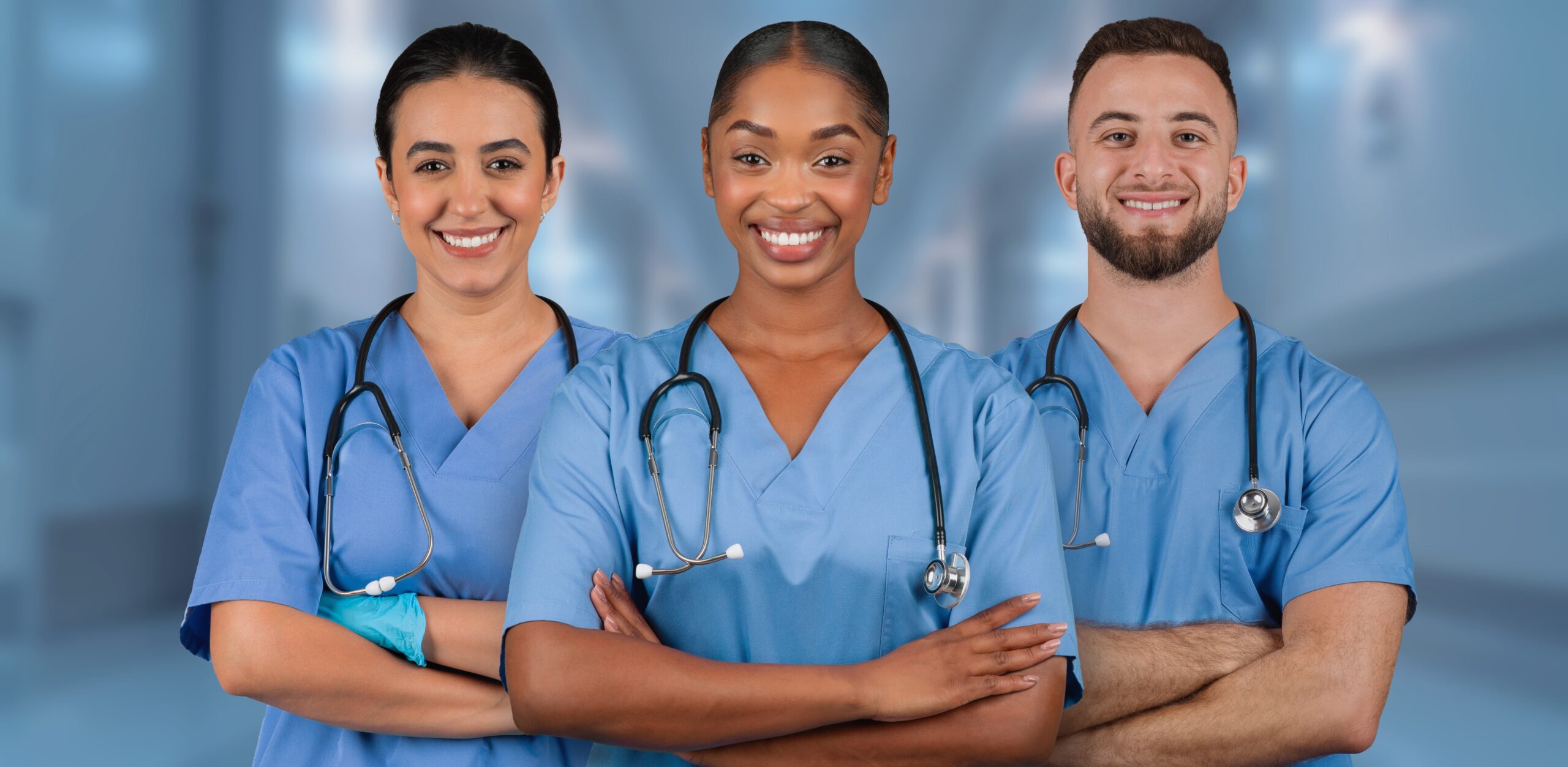 Three,International,Smiling,Healthcare,Professionals,In,Blue,Scrubs,With,Stethoscopes Non-Medical Senior Care